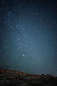 Portrait view of milky way from down under with rocks