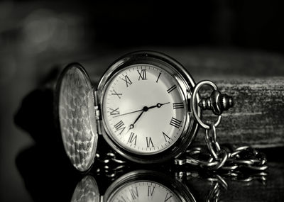 Close-up of pocket watch on table