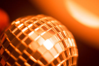 Close-up of disco ball against illuminated background