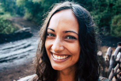 Close-up portrait of smiling young woman