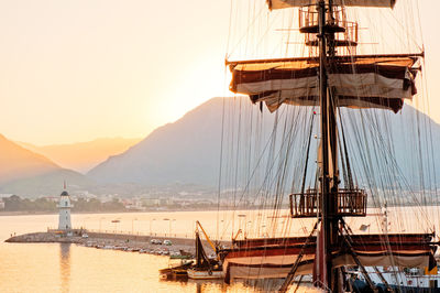 Sailboats moored in sea against clear sky