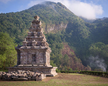 Temple by building against sky