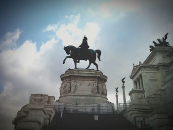 Low angle view of statue against cloudy sky