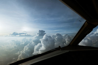 Low angle view of silhouette window against sky