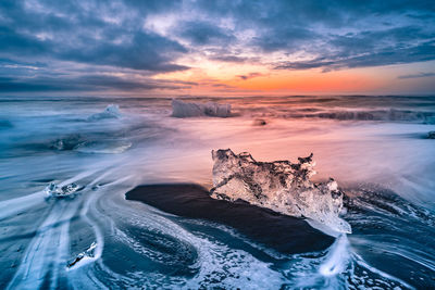 Scenic view of sea against sky at sunset