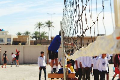 People by volleyball net