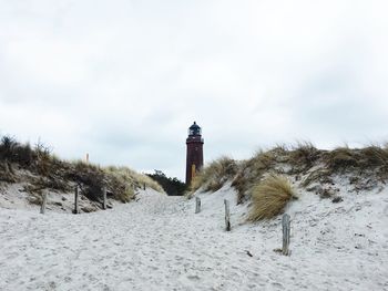 Lighthouse against cloudy sky