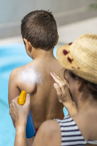 Rear view of shirtless boy in bathroom