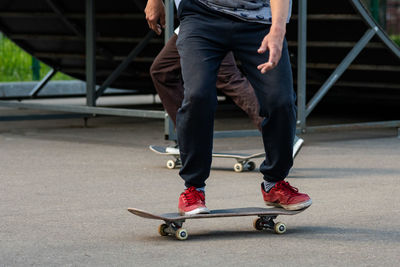 Low section of man skateboarding on skateboard