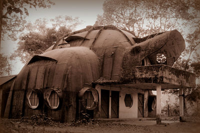 Abandoned built structure against trees