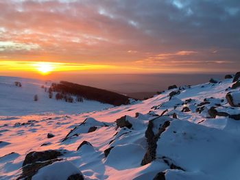 Scenic view of snow mountains against sky during sunset