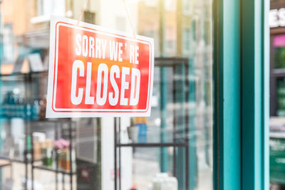 Close-up of sign on glass window