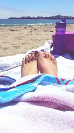 Low section of woman lying on beach