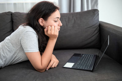 Young woman using laptop at home