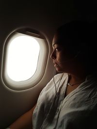 Close-up of woman sitting in airplane