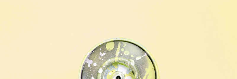 Close-up of yellow wheel against white background