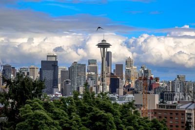 View of cityscape against cloudy sky