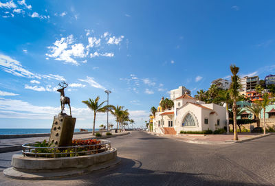 Traditional building by road against sky in city