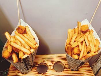 High angle view of french fries in paper containers 