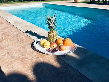 High angle view of fruits on table at swimming pool