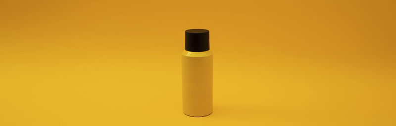 Close-up of electronic cigarette against yellow background