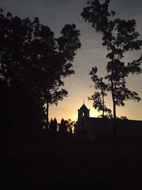 Silhouette built structure against sky at sunset