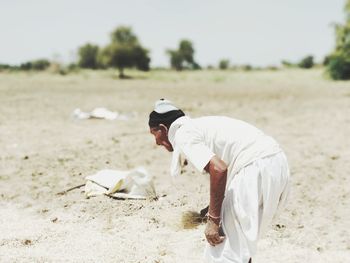 Side view of man playing on field