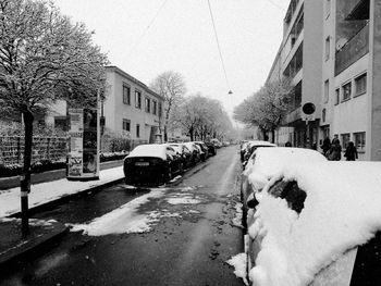 Cars on road in city during winter