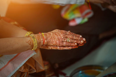 Cropped hands of bride with henna tattoo