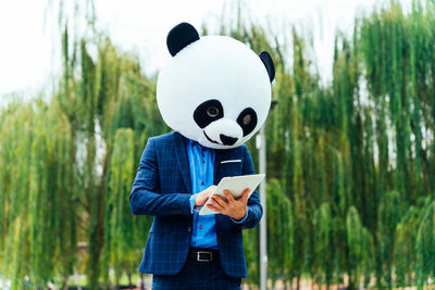 Rear view of woman standing in forest