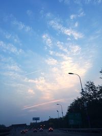 Traffic on road at sunset