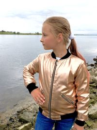 Full length of teenage girl standing in lake