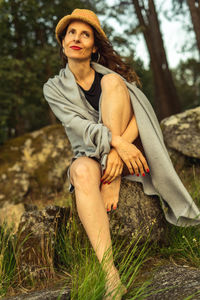 Woman sitting on a stone