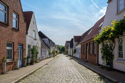 Empty alley amidst buildings in city