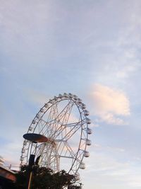 Low angle view of ferris wheel against sky