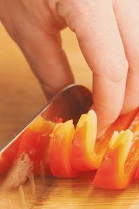 Close-up of person preparing food on cutting board