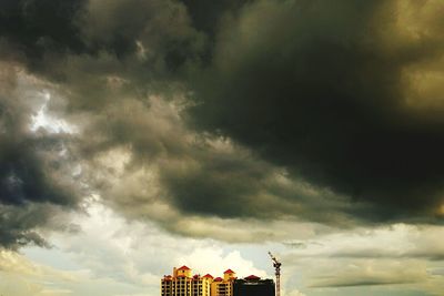 Low angle view of building against cloudy sky