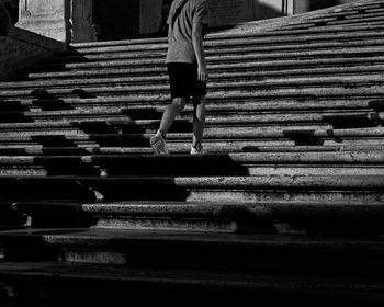 Low section of woman walking on staircase