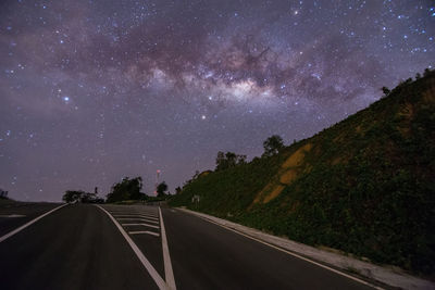 Empty road against sky at night