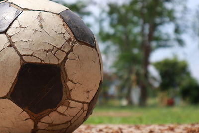 Close-up of old ball on field