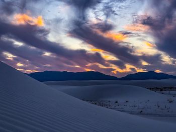 Scenic view of snowcapped mountains against sky during sunset