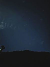 Low angle view of silhouette trees against sky at night