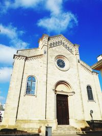 Low angle view of bell tower against sky