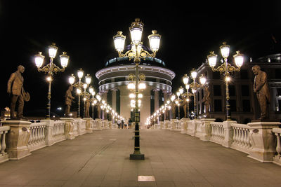 Illuminated archway against sky at night