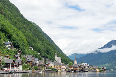 Townscape by mountain against sky