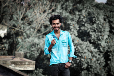 Portrait of young man standing outdoors