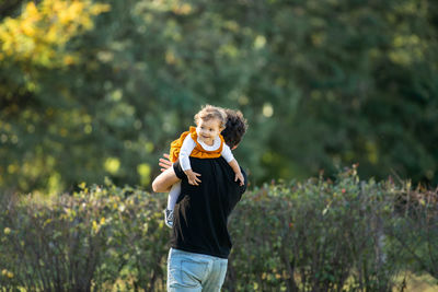 Full length of man standing against plants