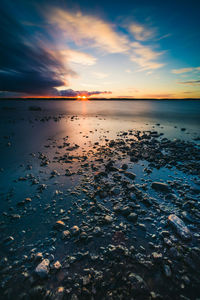 Scenic view of calm sea at sunset