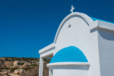 Low angle view of building against clear blue sky