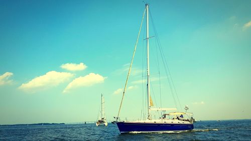 Sailboat on sea against blue sky